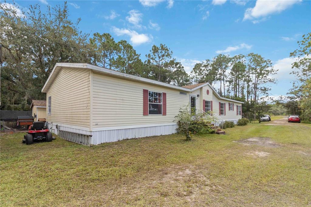 6701 Nova Road St. Cloud, FL 34771 - Photo 7 of 49 a view of a house with a yard