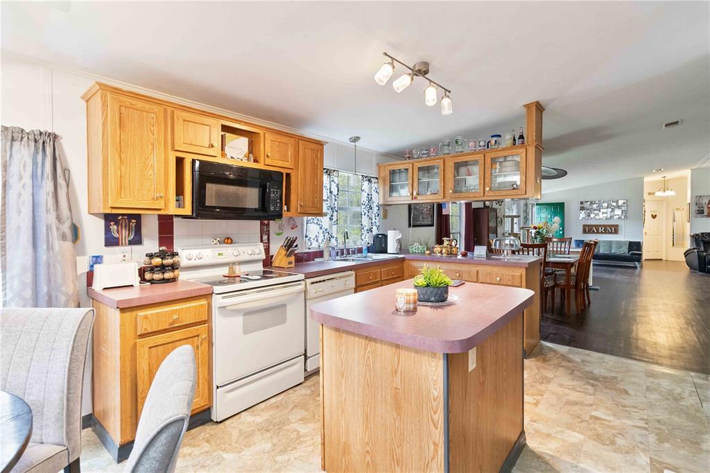 6701 Nova Road St. Cloud, FL 34771 - Photo 8 of 49 a kitchen with stainless steel appliances kitchen island granite countertop a sink and cabinets