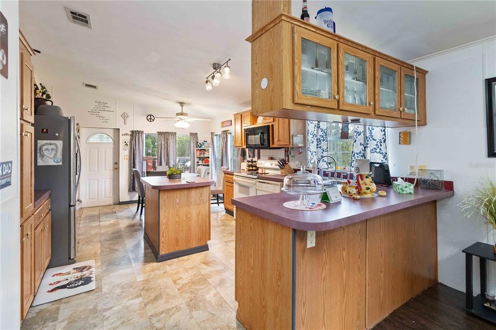 6701 Nova Road St. Cloud, FL 34771 - Photo 10 of 49 a kitchen with stainless steel appliances granite countertop a sink and cabinets