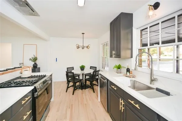 a kitchen with stainless steel appliances granite countertop a refrigerator and a stove