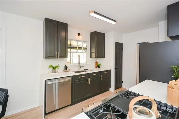 a living room with furniture fireplace and potted plant
