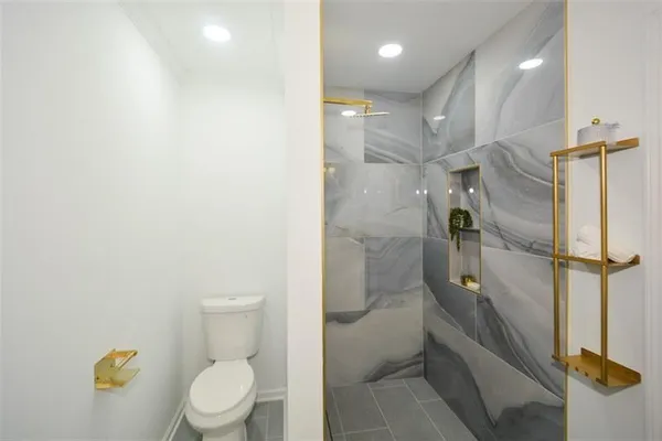 an empty room with closet and windows