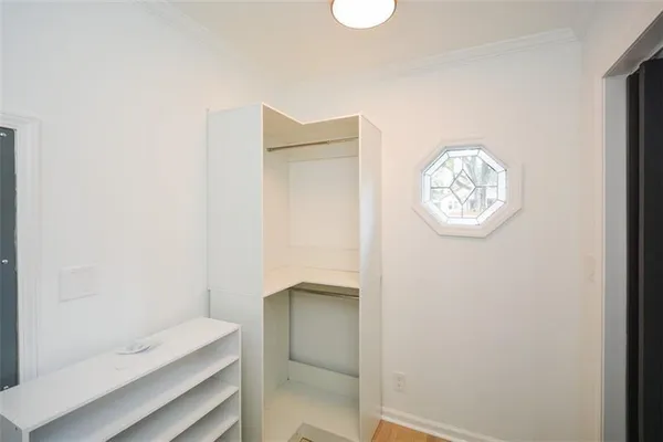 a bathroom with a toilet a sink a mirror and a window
