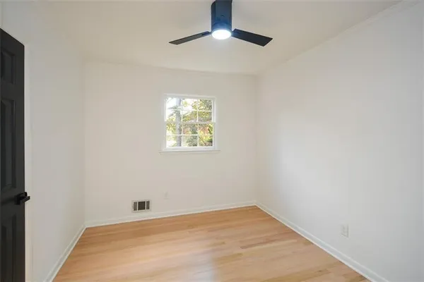 a bathroom with a bathtub and next to a window