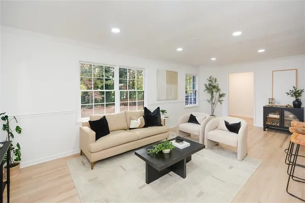 a living room with furniture and a wooden floor