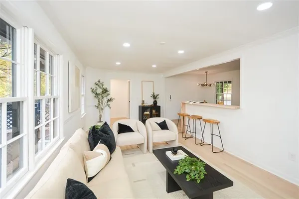 a living room with furniture a window and a table