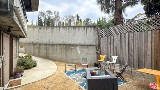 a backyard of a house with outdoor seating