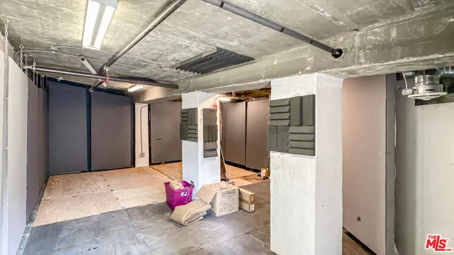 a view of parking garage with cars parked