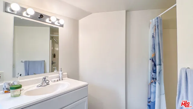 a bathroom with a sink vanity and a mirror