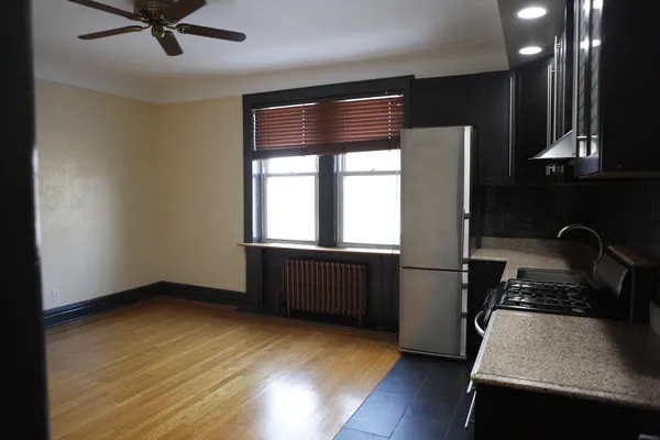 a kitchen with a refrigerator and a stove top oven