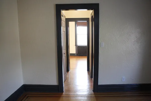 a view of front door with wooden floor