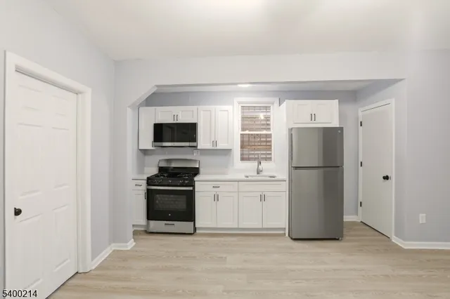 a kitchen with stainless steel appliances granite countertop a stove and a refrigerator