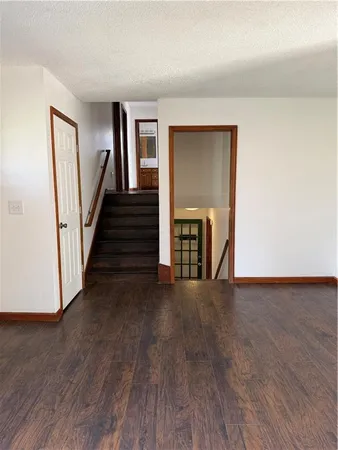 a view of an entryway with wooden floor