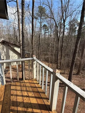 a view of balcony with wooden floor and fence