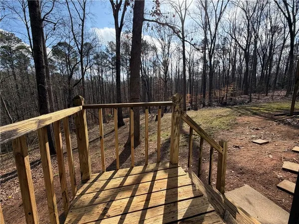a view of a balcony with wooden floor and outdoor space