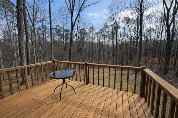 a view of balcony with wooden floor and outdoor seating
