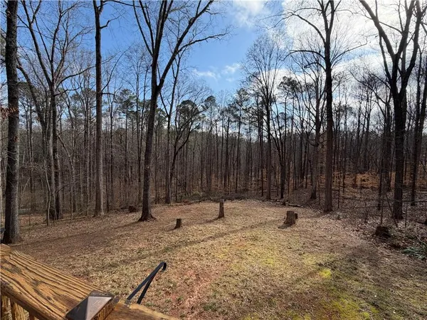 a view of wooden fence with trees