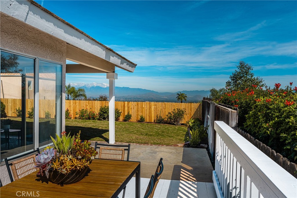 14312 Martin Riverside, CA 92503 - Photo 24 of 58 a view of a patio with table and chairs potted plants with wooden floor and fence