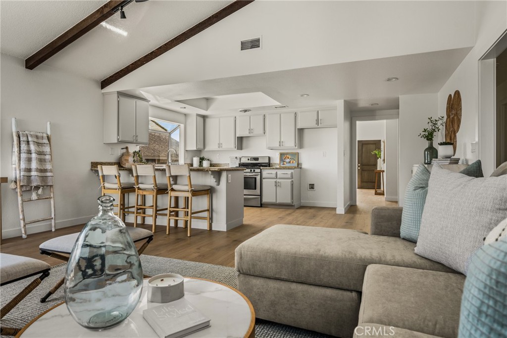 14312 Martin Riverside, CA 92503 - Photo 39 of 58 a living room with furniture kitchen view and a wooden floor