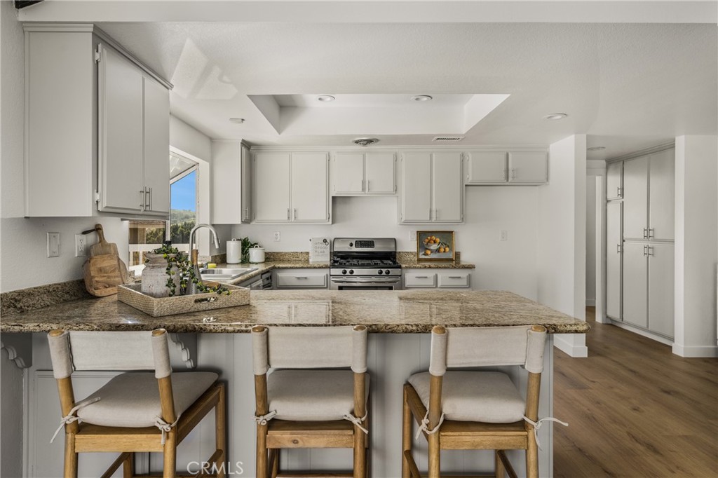 14312 Martin Riverside, CA 92503 - Photo 40 of 58 a kitchen with a dining table chairs refrigerator and cabinets