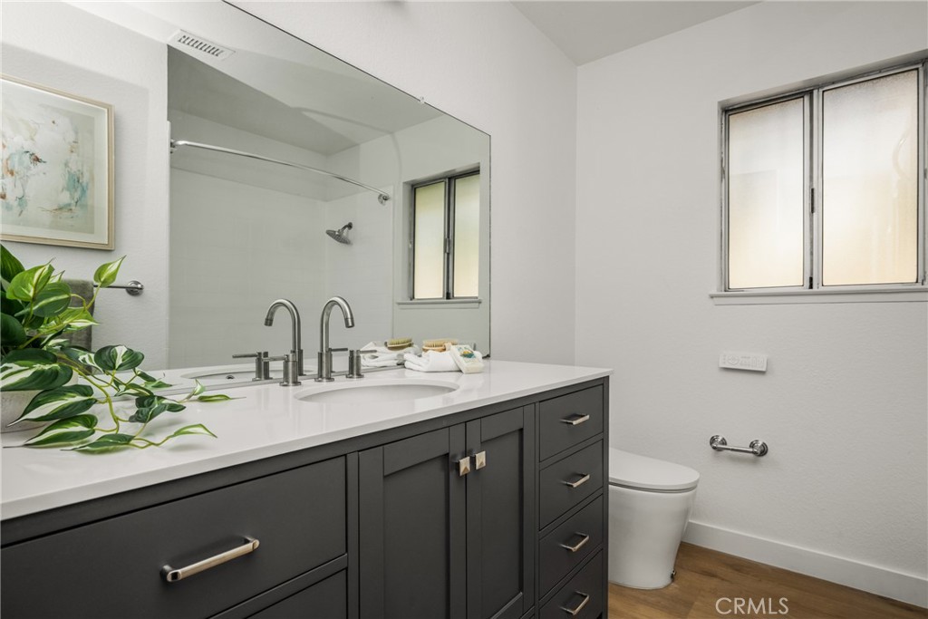 14312 Martin Riverside, CA 92503 - Photo 53 of 58 a bathroom with a granite countertop sink a toilet and a mirror