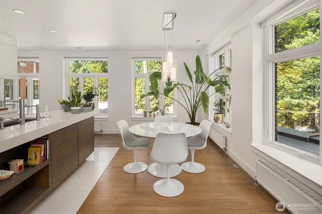 a large white kitchen with a large window