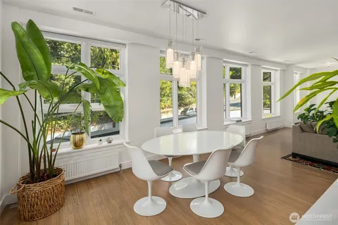 a dining room with furniture a potted plant and a chandelier
