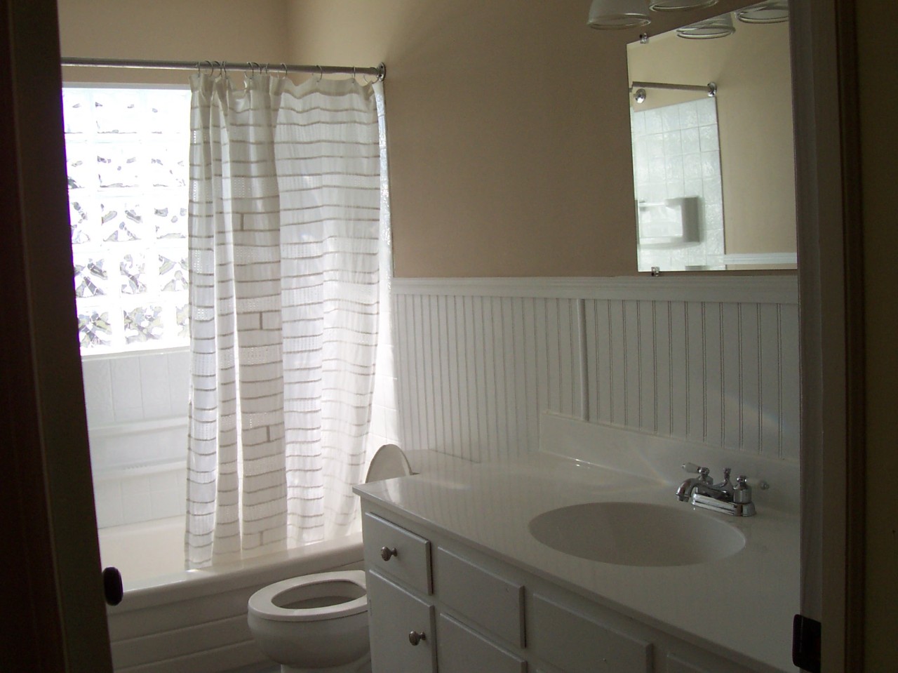 923 Olney Road Vinton, VA 24179 - Photo 5 of 6 a bathroom with a granite countertop sink toilet a mirror and shower