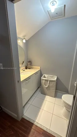 a bathroom with a sink mirror and toilet