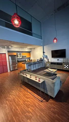 a living room with dining room and wooden floor