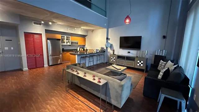 a dining room with furniture and a flat screen tv