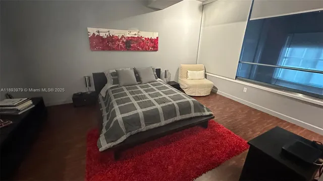 a bedroom with bed and a window