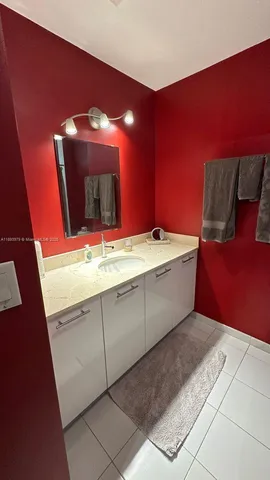 a bathroom with a sink a mirror and vanity