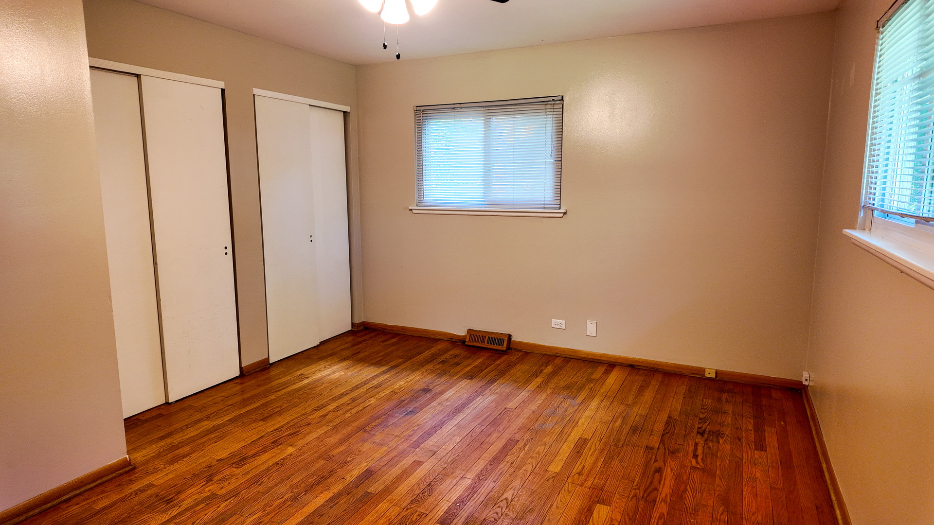 3506 Ithaca Road Olympia Fields, IL 60461 - Photo 15 of 28 an empty room with wooden floor and windows