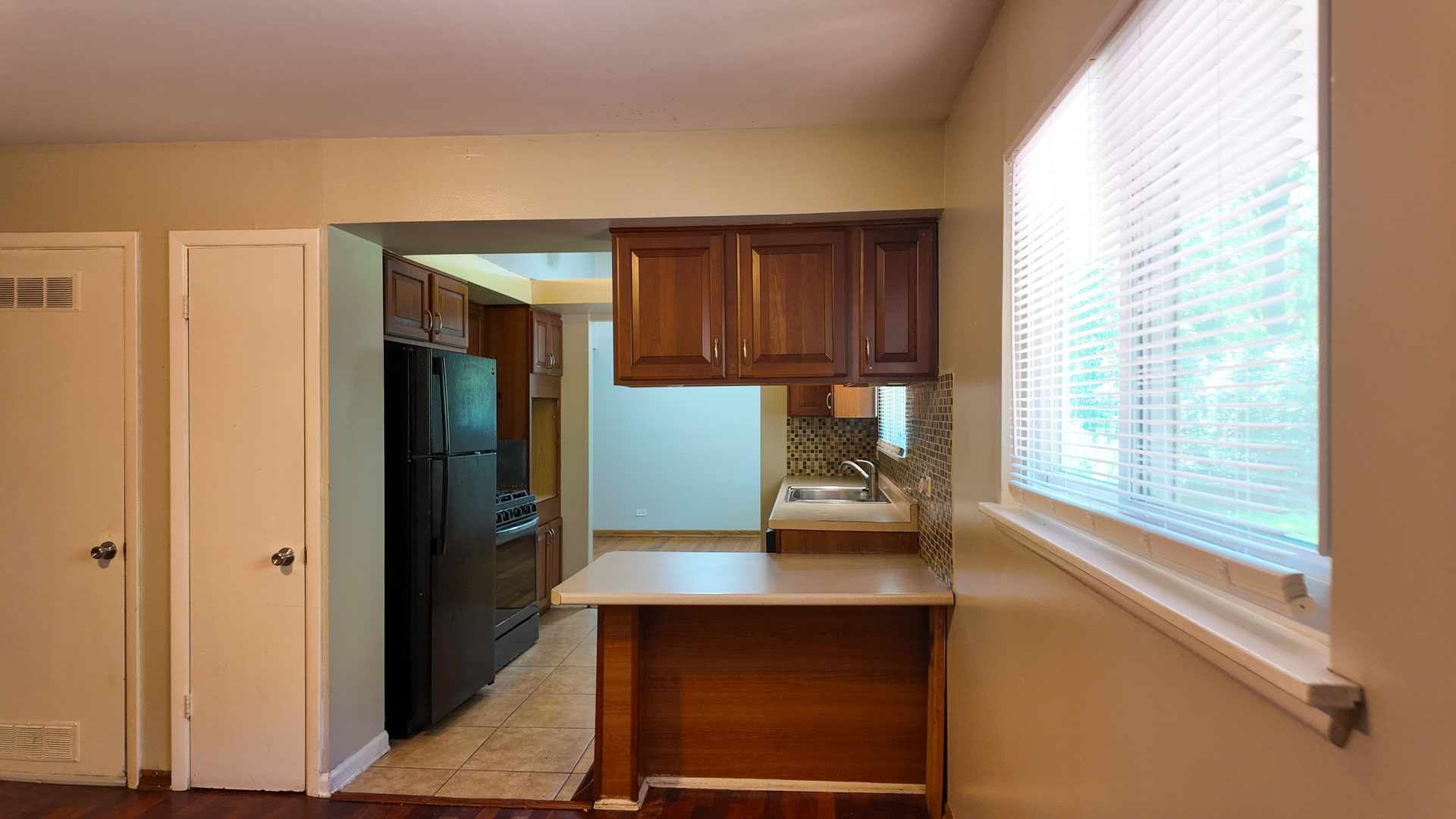 3506 Ithaca Road Olympia Fields, IL 60461 - Photo 16 of 28 a kitchen with wooden floor and furniture