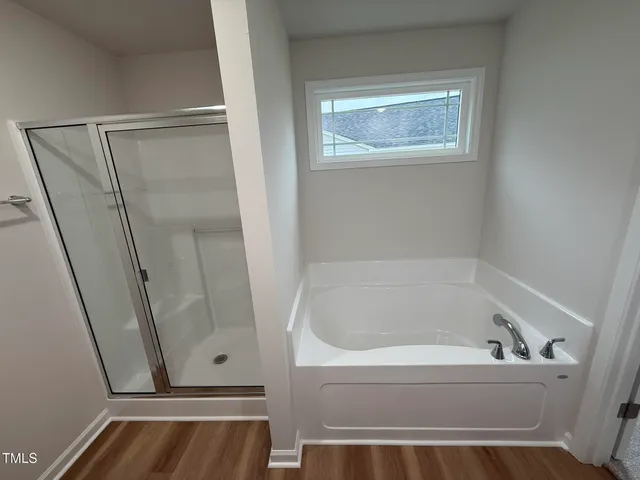 a bathroom with bathtub and shower