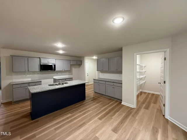 a large kitchen with cabinets and stainless steel appliances