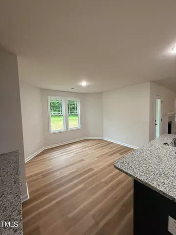 a view of a kitchen and wooden floor