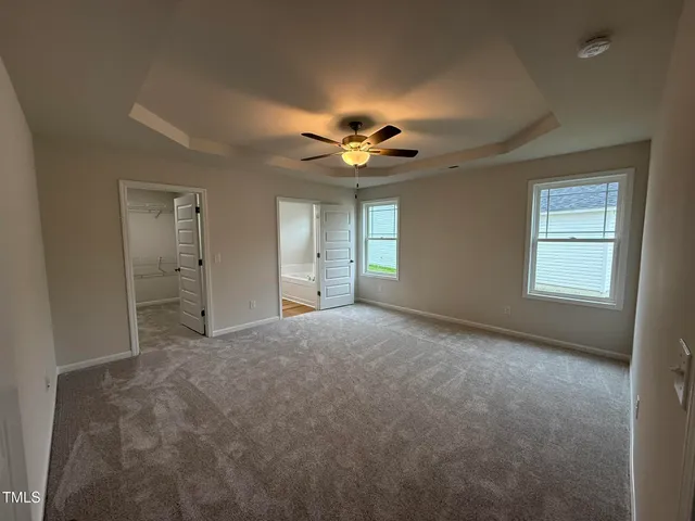 a view of a livingroom with a ceiling fan and window