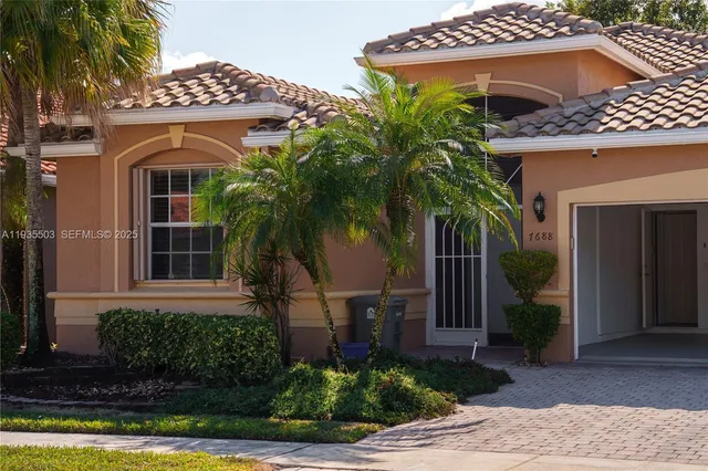 front view of a house with potted plants