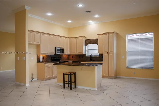 a kitchen with stainless steel appliances a refrigerator stove microwave and cabinets