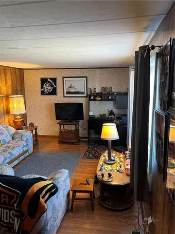 a living room with furniture and a lamp