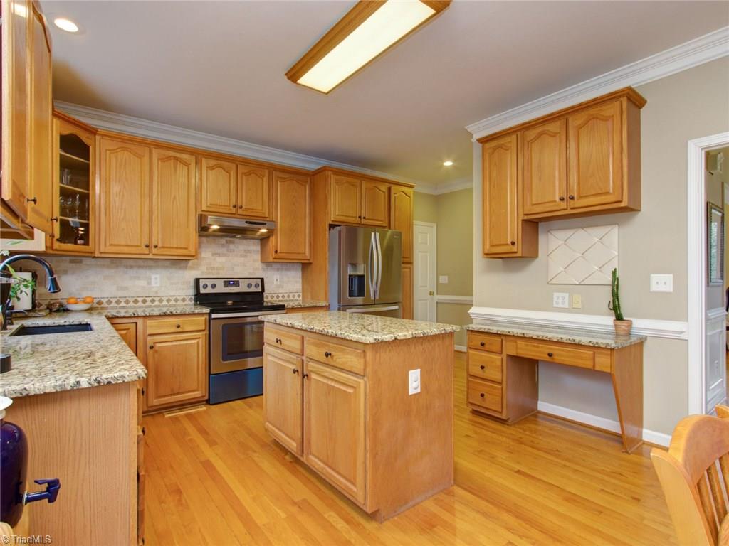 8118 Chestershire Road Oak Ridge, NC 27310 - Photo 5 of 19 Lovely, spacious kitchen with new granite, backsplash and stainless steel appliances. The seller left some blue protection on the new stove to keep it totally new for YOU!