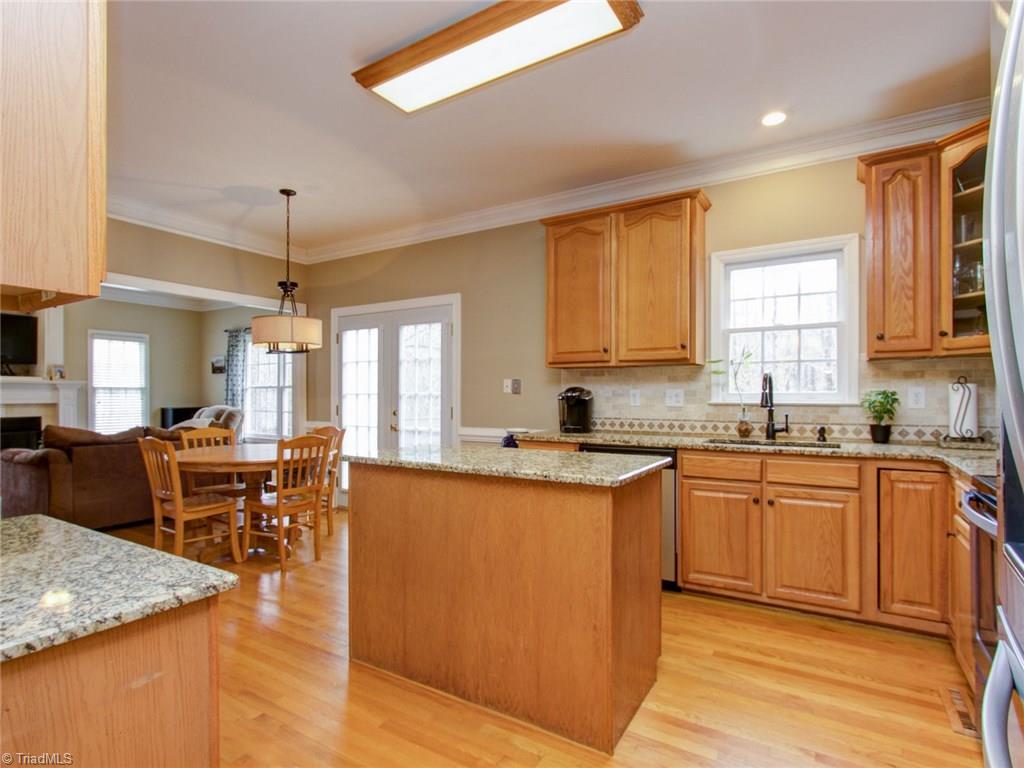 8118 Chestershire Road Oak Ridge, NC 27310 - Photo 6 of 19 The open kitchen was a new design by the sellers and they added the new doors out unto the deck.