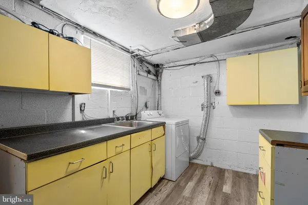 a kitchen with sink cabinets and stove
