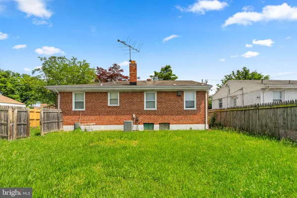 a front view of a house with a yard and green space
