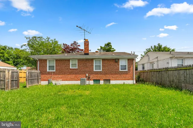 a front view of a house with a yard and green space