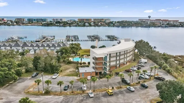 aerial view of a house with outdoor seating and lake view