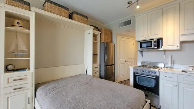 a kitchen with a refrigerator stove and microwave
