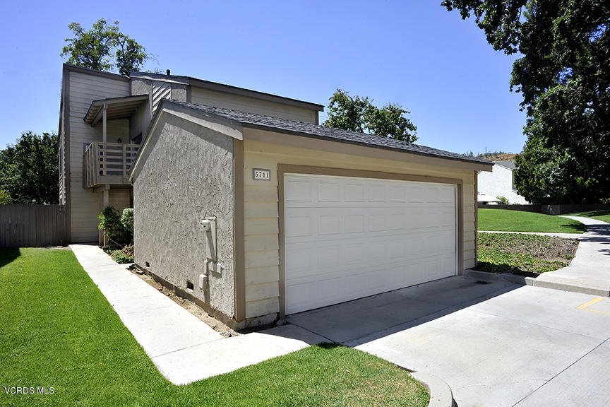 5711 Cochran Street Simi Valley, CA 93063 - Photo 1 of 25 a view of backyard with potted plants and a large tree